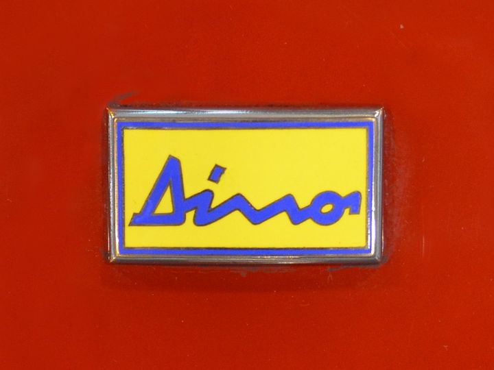 The Dino badge, Alfredo Ferrari's signature in blue on yellow enamel