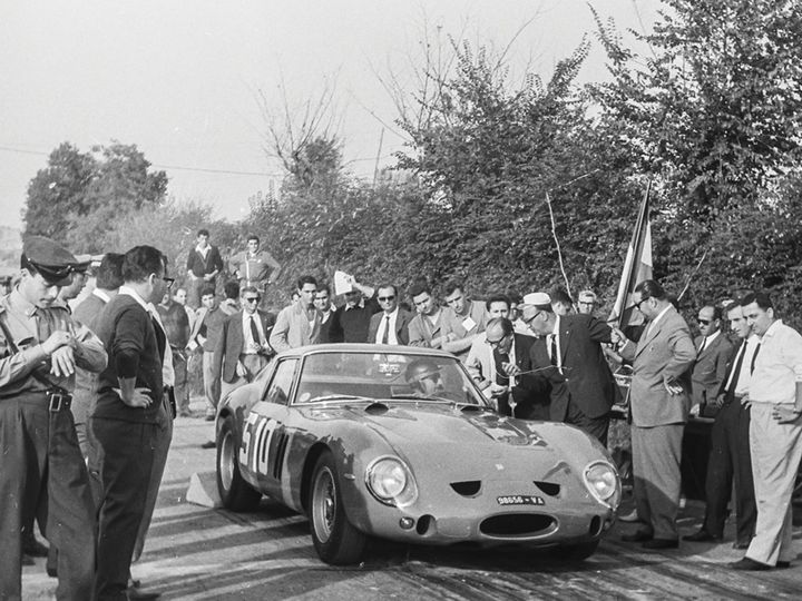 A Ferrari 250 GTO surrounded by a crowd after winning the Coppa Fagioli in 1962