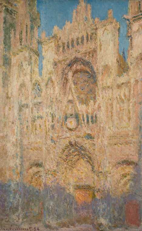 The same façade of Rouen Cathedral in warm orange evening light